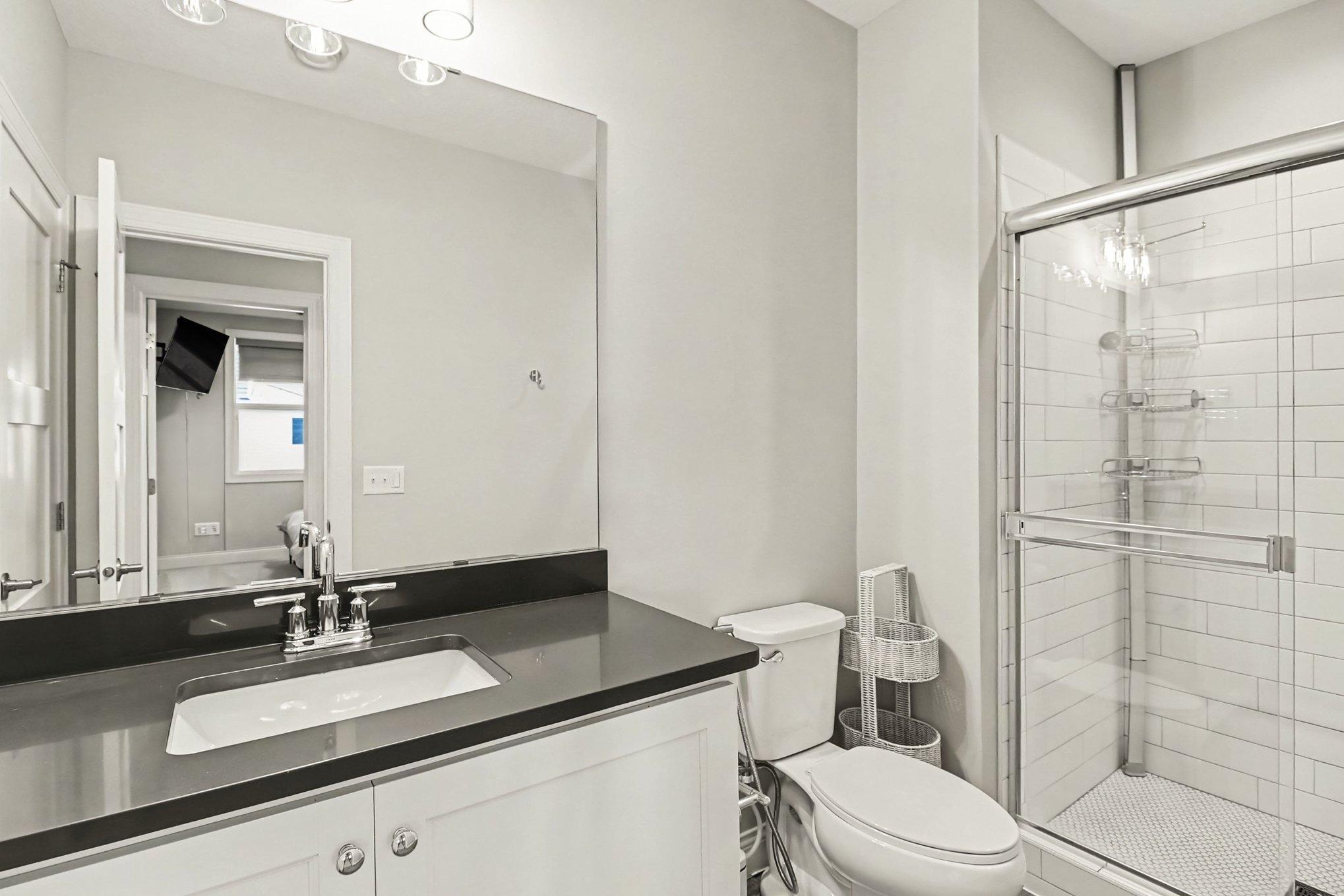 Custom tiled lower-level full bathroom.