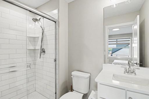 2nd bedroom ensuite with custom tiled shower.
