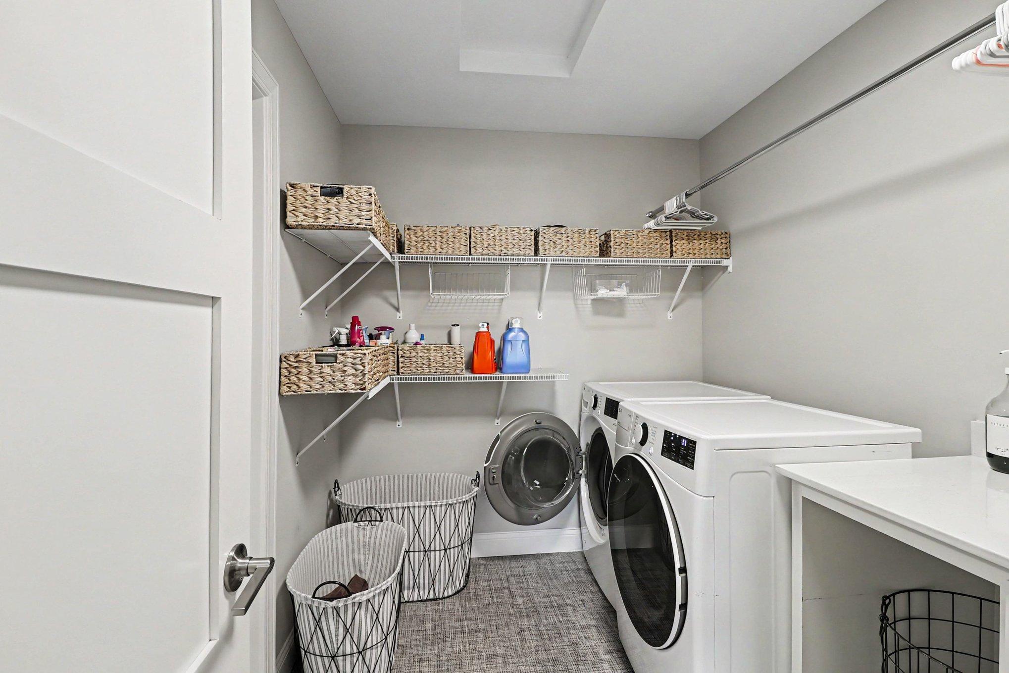 The upper laundry off the loft has access from the primary and other bedrooms.