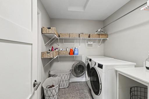 The upper laundry off the loft has access from the primary and other bedrooms.