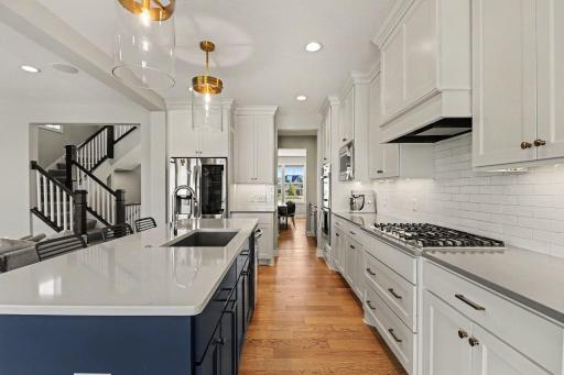 Light, bright, and inviting kitchen. View from the informal dining room to the front of the home.