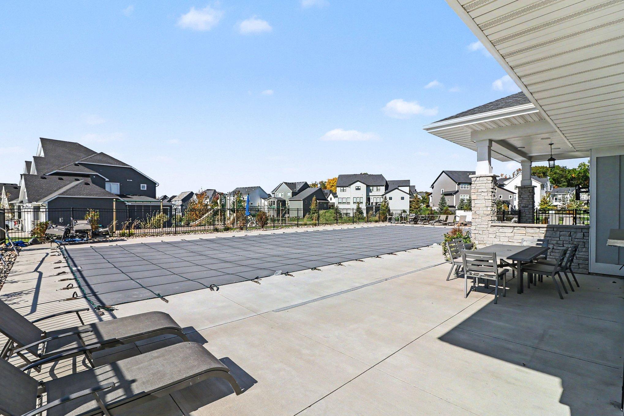 The neighborhood clubhouse and pool can be seen from the deck and patio