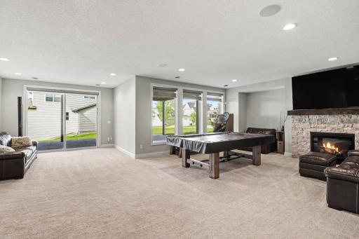 The walkout lower level features a stone-surround gas fireplace.
