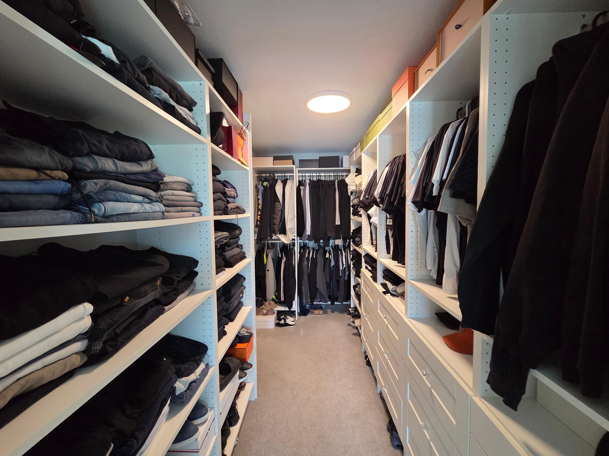A large primary closet with its own access to the laundry room.
