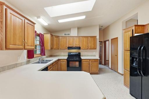 Kitchen, also showing pantry closet and hallway to bedrooms 2 and 3 as well as the main floor bath