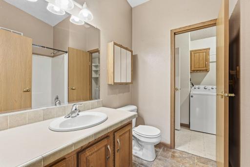 Full bath adjoins bedroom one and laundry