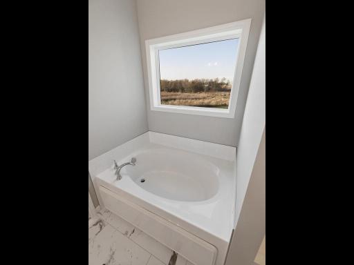 PHOTO OF A DIFFERENT HOME WITH SIMILAR PLAN. FINISHES MAY VARY. Primary Bath Soaking Tub.