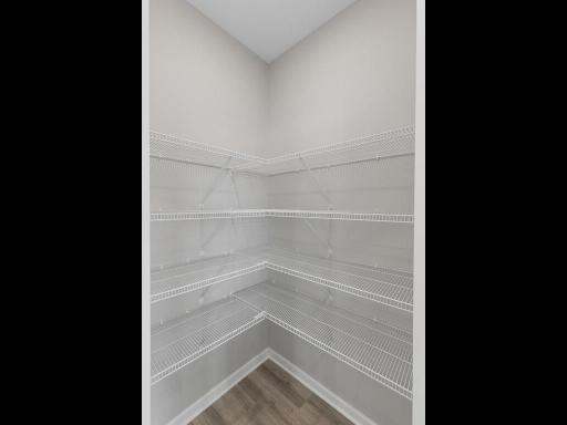 PHOTO OF A DIFFERENT HOME WITH SIMILAR PLAN. FINISHES MAY VARY. Kitchen Pantry.
