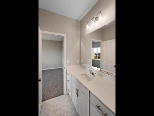 PHOTO OF A DIFFERENT HOME WITH SIMILAR PLAN. FINISHES MAY VARY. Jack n Jill Bath serves bedrooms 2 and 3.