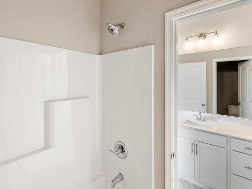 PHOTO OF A DIFFERENT HOME WITH SIMILAR PLAN. FINISHES MAY VARY. Jack n Jill Bath serves bedrooms 2 and 3.