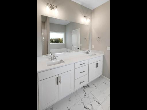 PHOTO OF A DIFFERENT HOME WITH SIMILAR PLAN. FINISHES MAY VARY. Primary Bath Double Sink Vanity.
