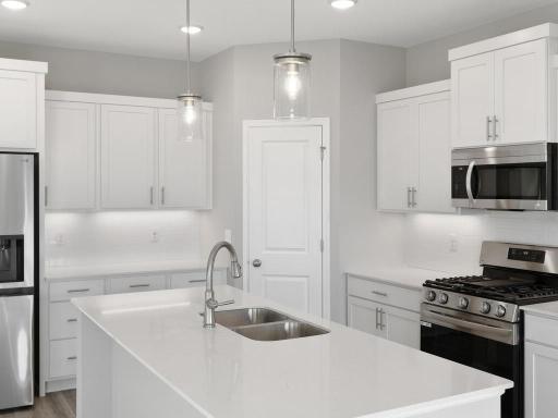 PHOTO OF A DIFFERENT HOME WITH SIMILAR PLAN. FINISHES MAY VARY. Kitchen features a spacious center island and corner walk-in pantry.
