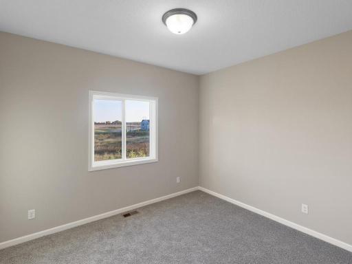 PHOTO OF A DIFFERENT HOME WITH SIMILAR PLAN. FINISHES MAY VARY. Bedroom 3.