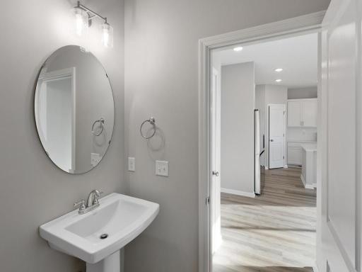 PHOTO OF A DIFFERENT HOME WITH SIMILAR PLAN. FINISHES MAY VARY. Main floor half bath.