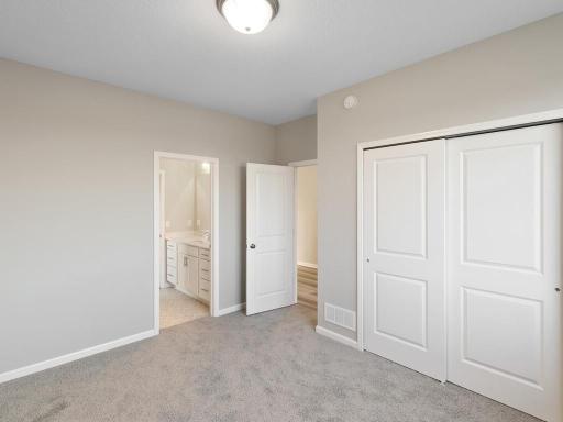 PHOTO OF A DIFFERENT HOME WITH SIMILAR PLAN. FINISHES MAY VARY. Bedroom 2.