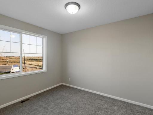 PHOTO OF A DIFFERENT HOME WITH SIMILAR PLAN. FINISHES MAY VARY. Bedroom 2.
