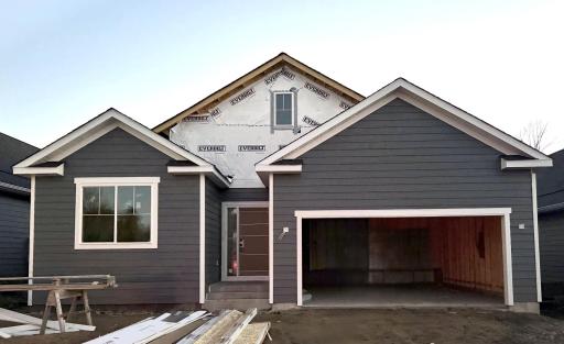 13773 102nd Ct N- Photo of actual home under construction offering an estimated December move-in. Siding installation will soon be complete.