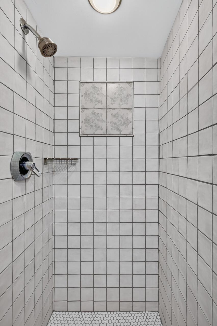 Newly tiled shower in lower level 3/4 bath.