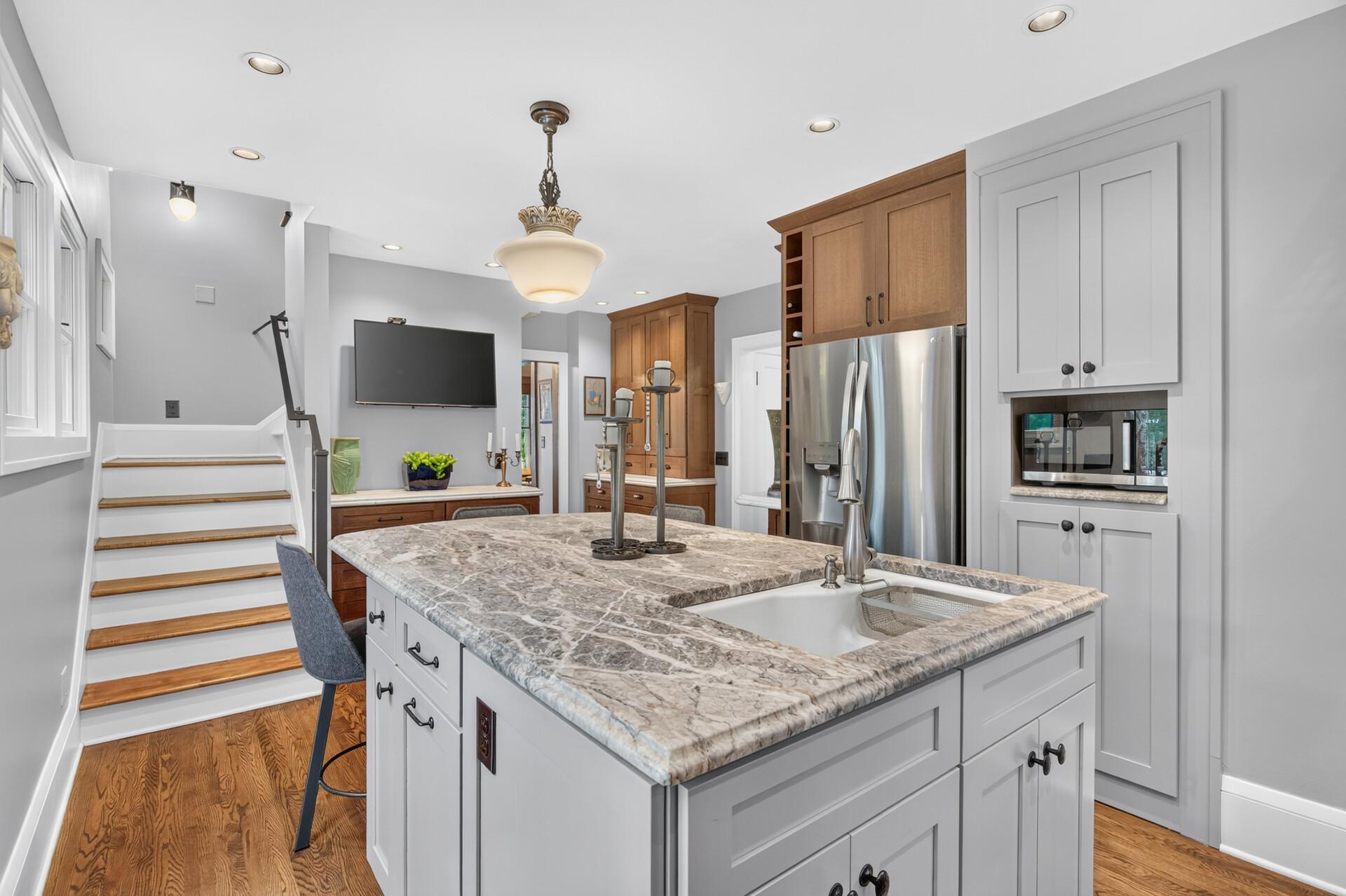 Large island anchors this spacious, beautifully updated kitchen.