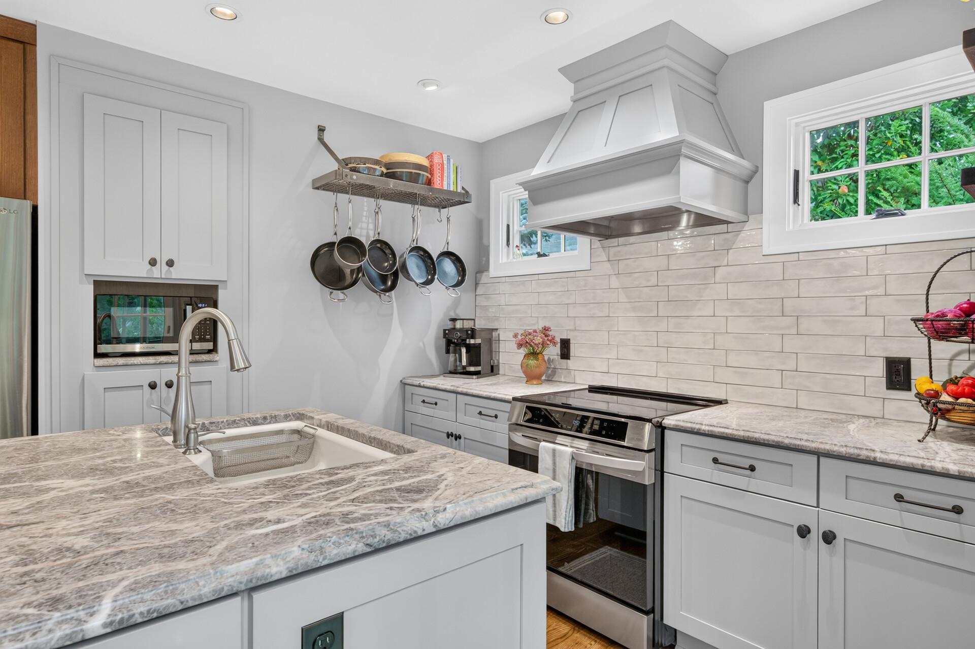 Custom cabinetry, marble surfaces and stainless steel appliances.