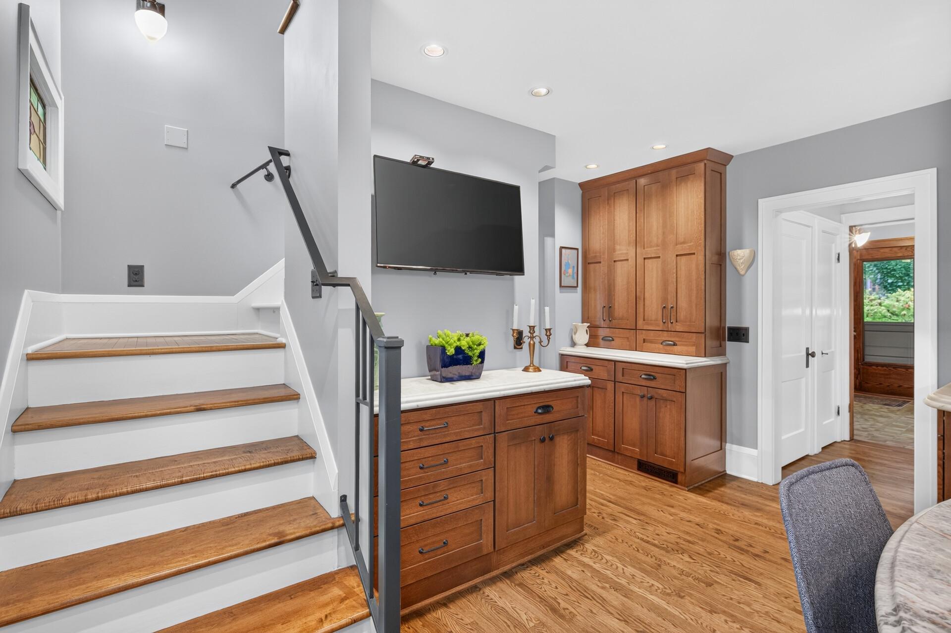 Custom built-in buffet and floor-to-ceiling pantry cabinetry add beautiful storage and character just off the kitchen.
