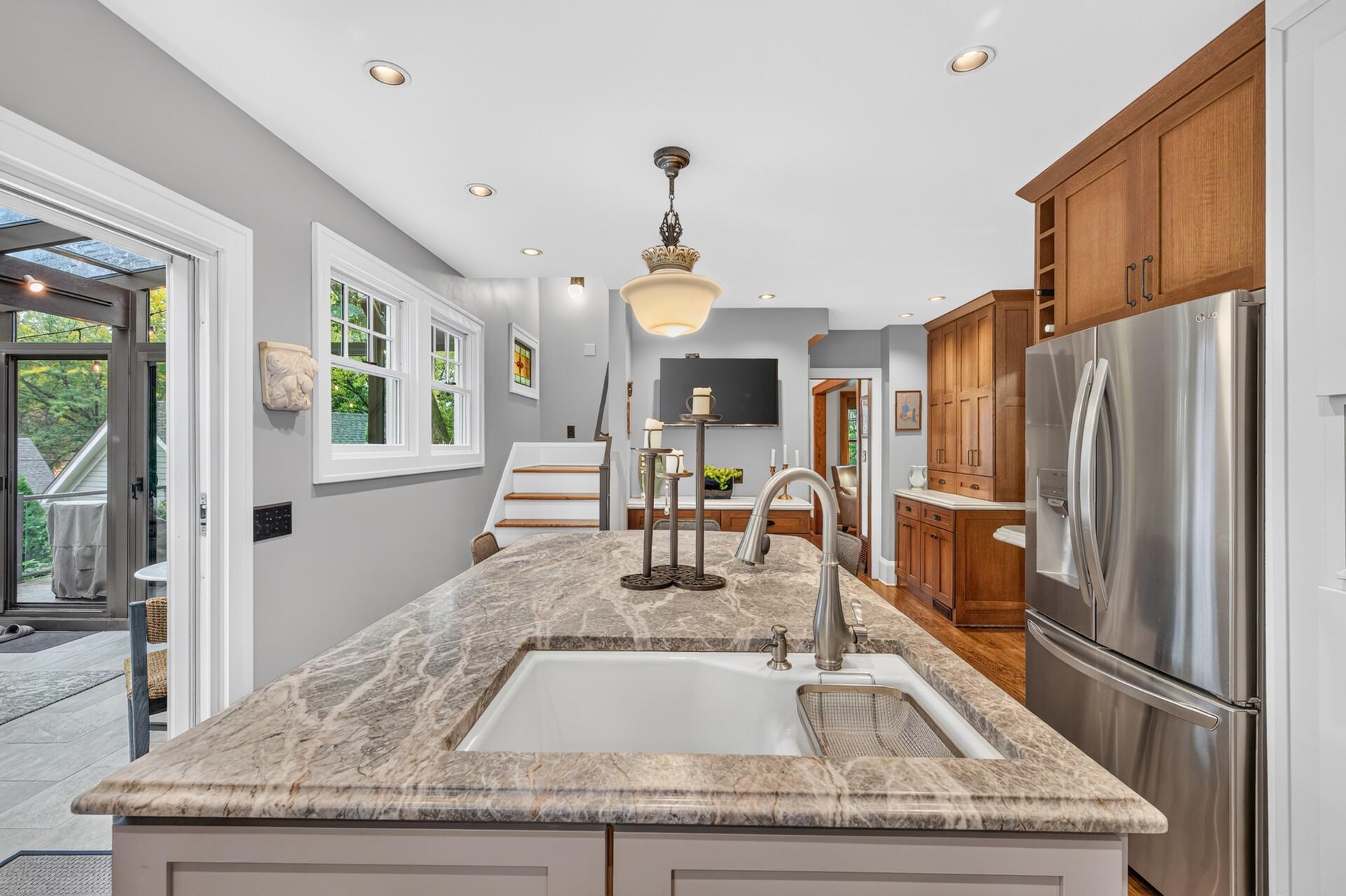Open kitchen design connects easily with the surrounding living spaces.