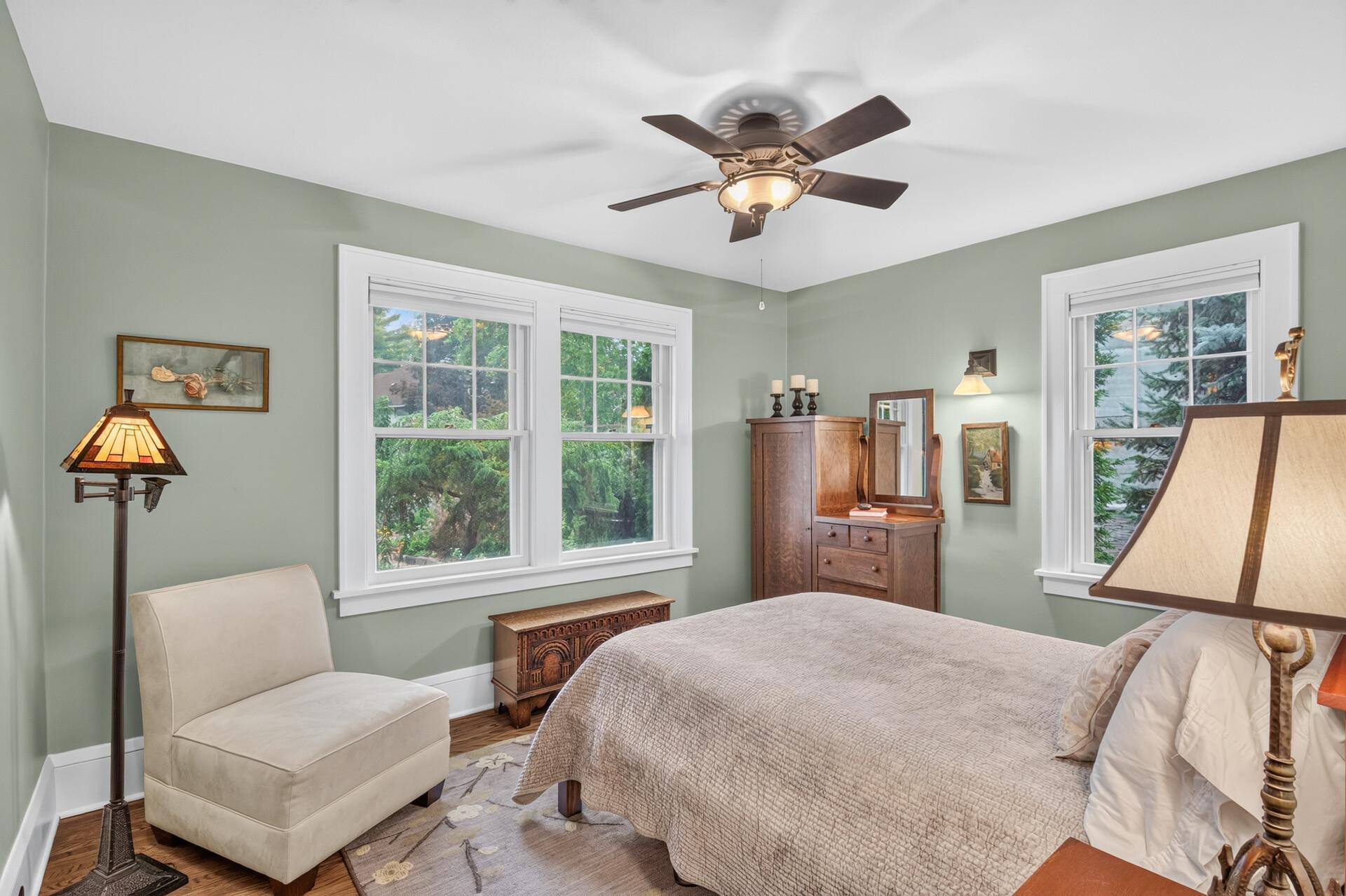 Comfortable main-level bedroom with hardwood floors and natural light.