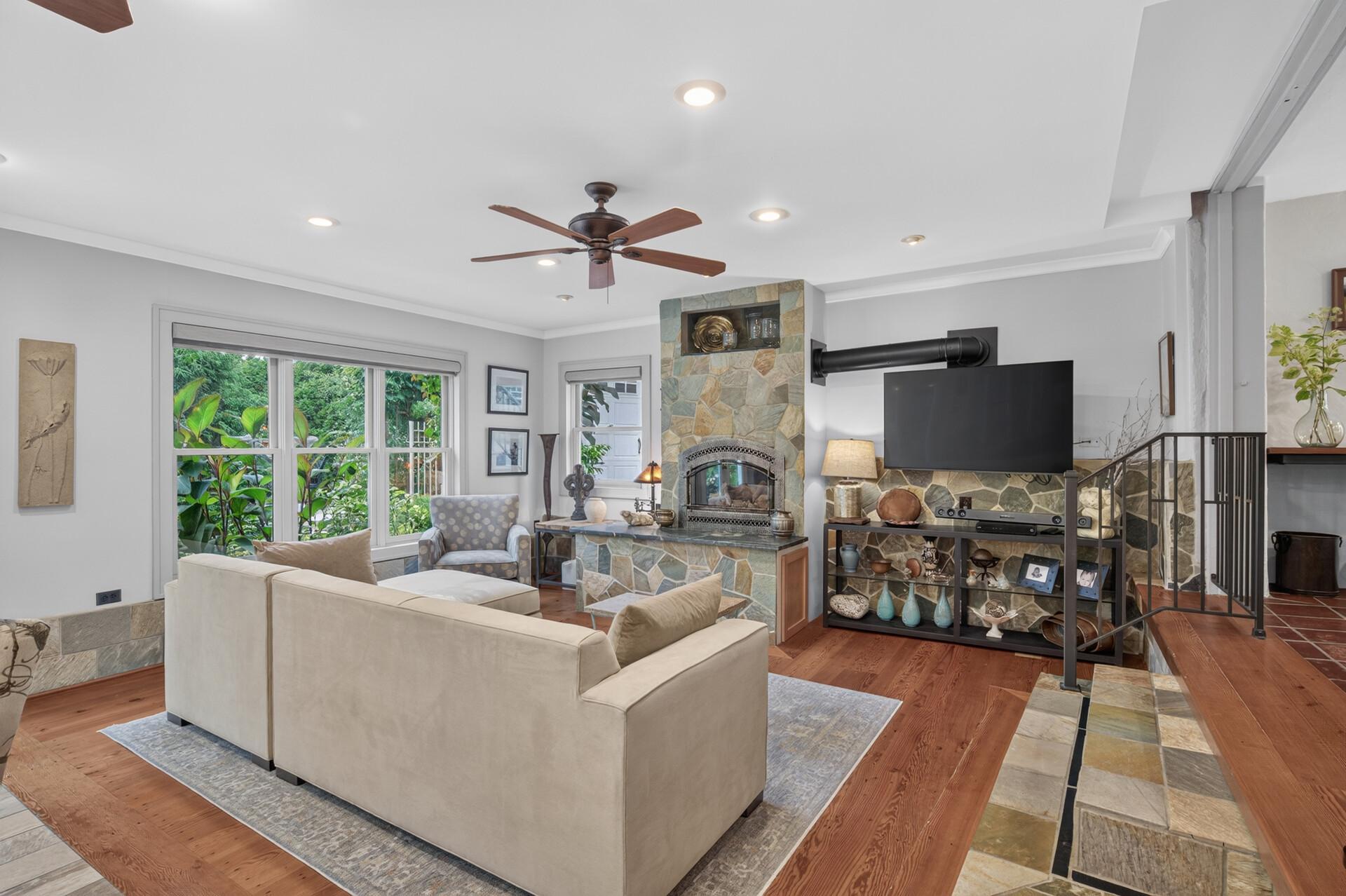 Spacious lower-level family room with gas fireplace and abundant natural light.