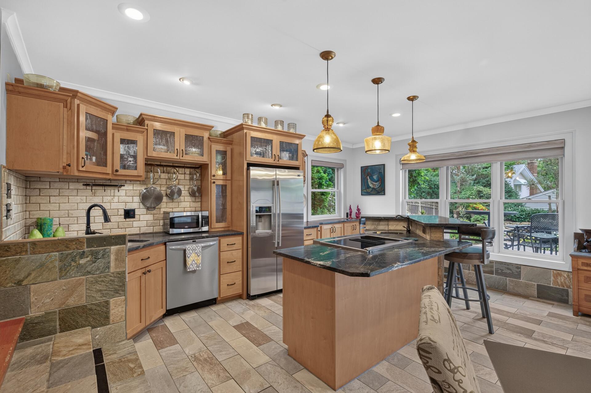Lower-level kitchen provides excellent workspace and storage.