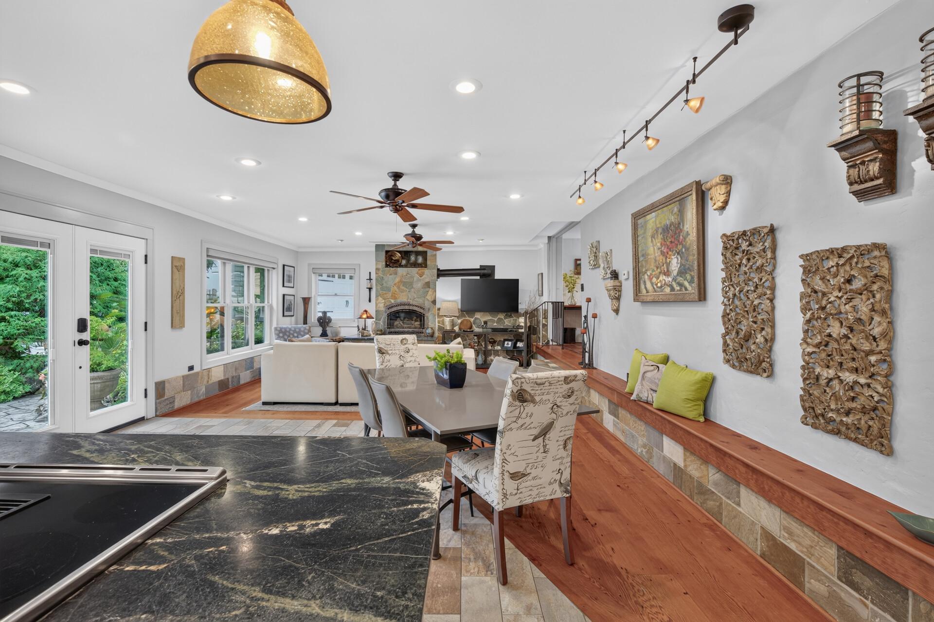 View from the lower-level kitchen through the dining area and into the spacious family room, highlighting the open and connected layout.