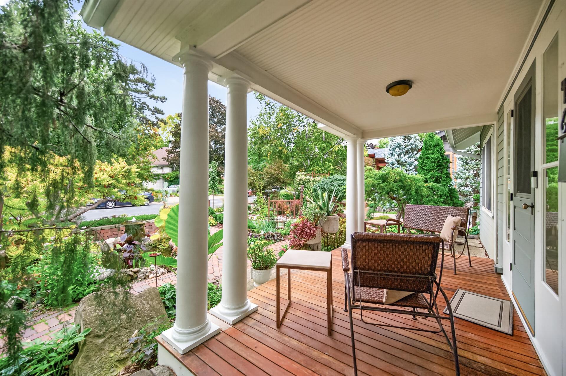 Beautiful porch details include wood flooring, substantial beam supports and garden views.