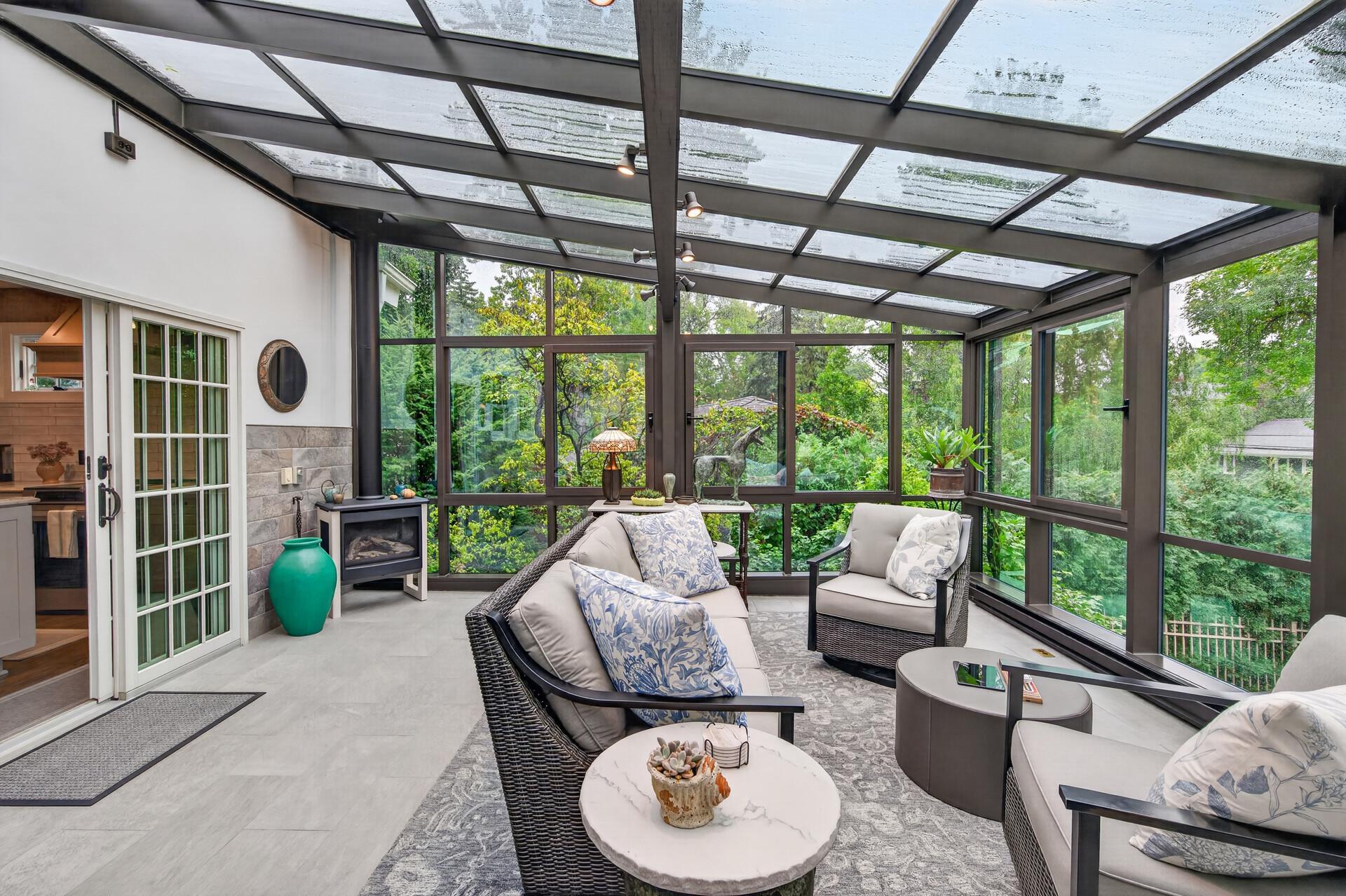The solarium creates a seamless transition from the home to the outdoor living spaces.