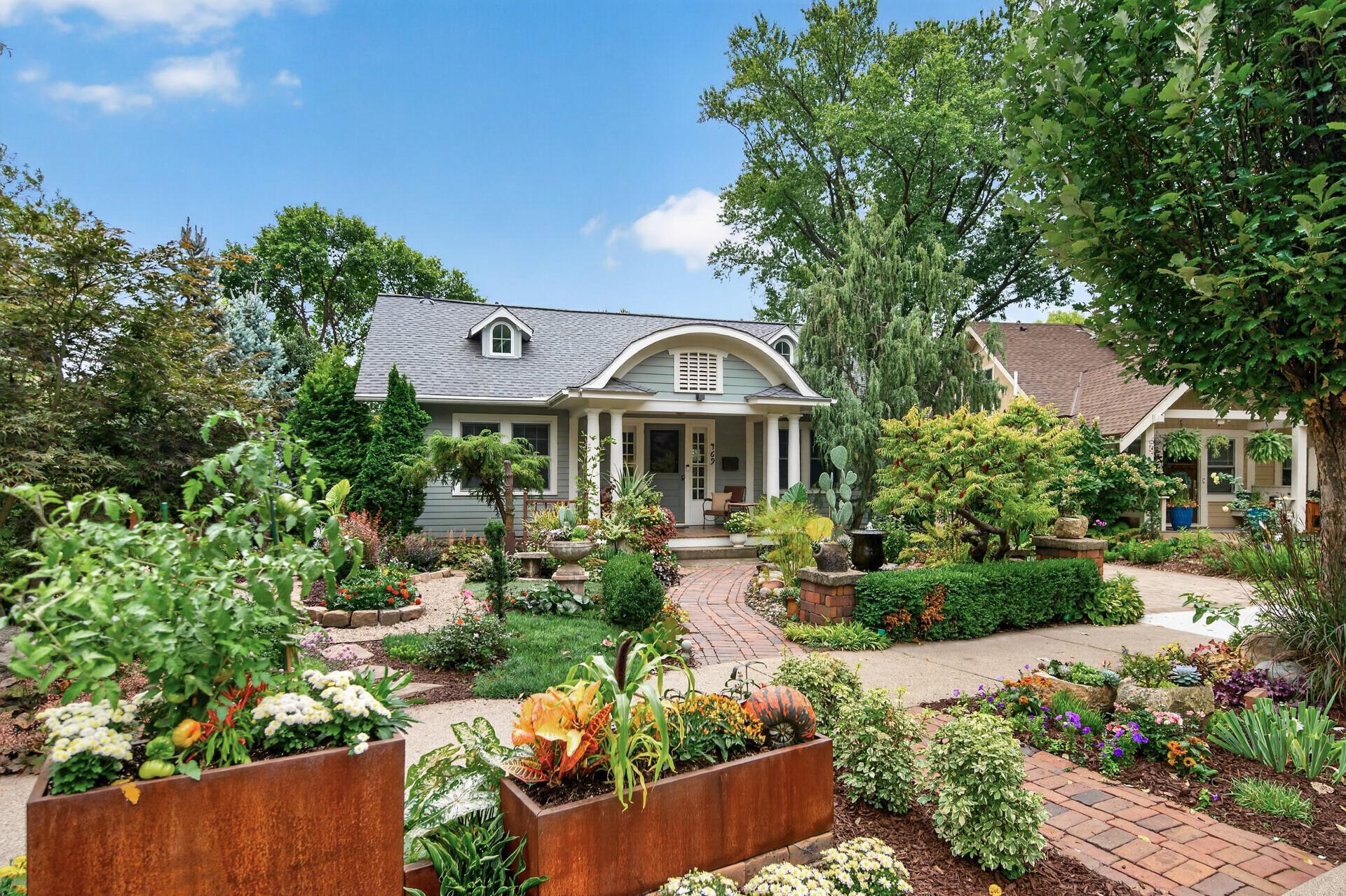 Exceptional Bryn Mawr curb appeal framed by beautifully designed gardens.