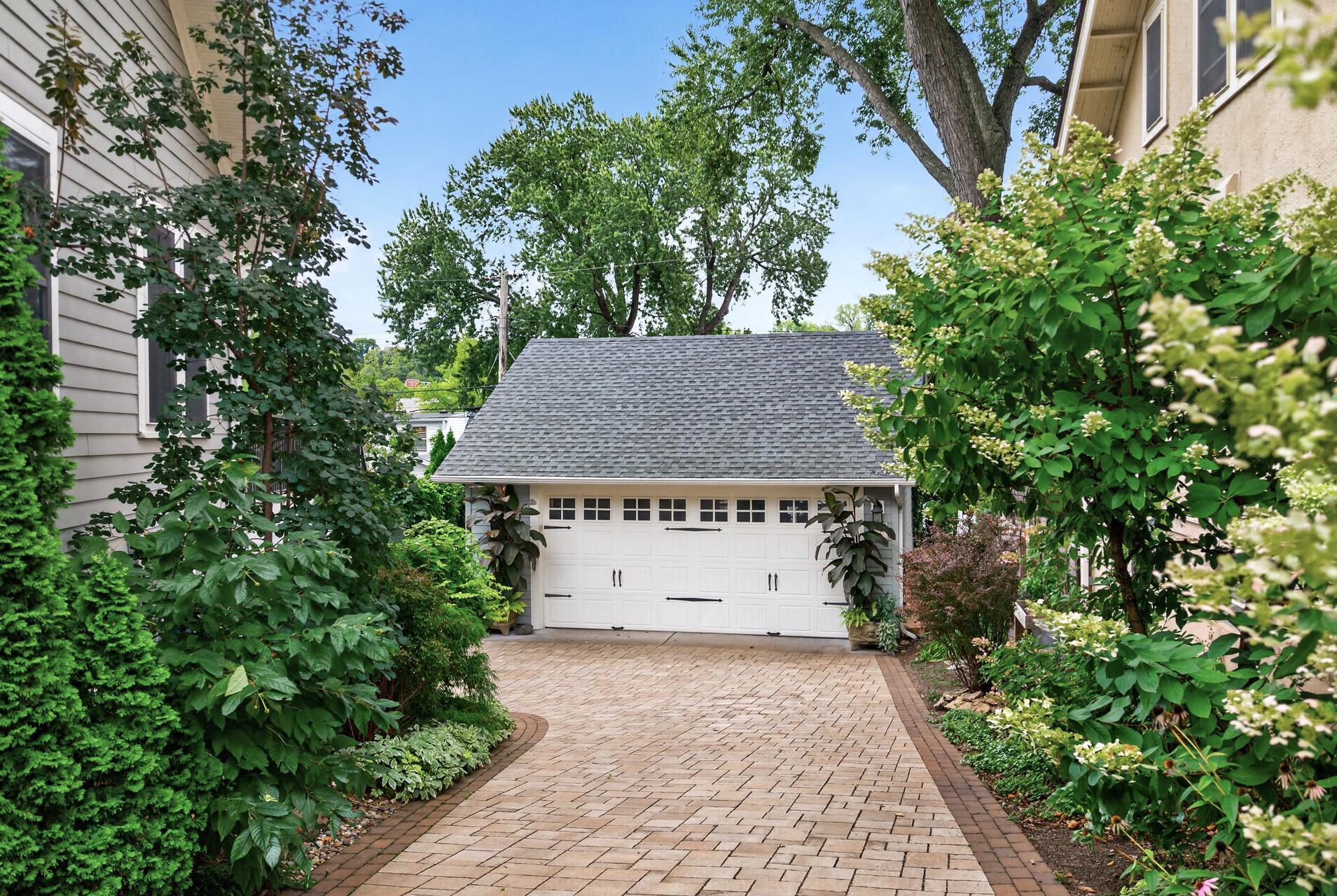 Beautiful paver driveway leads to the two-car garage.
