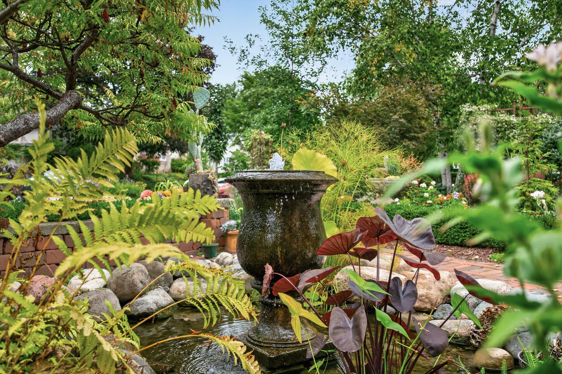 A closer look at the beautiful pond, water feature and surrounding plantings.