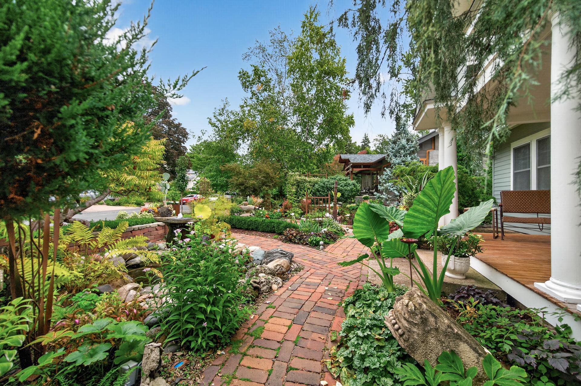 Layered landscaping creates a beautiful, intimate setting around the front porch and entry.