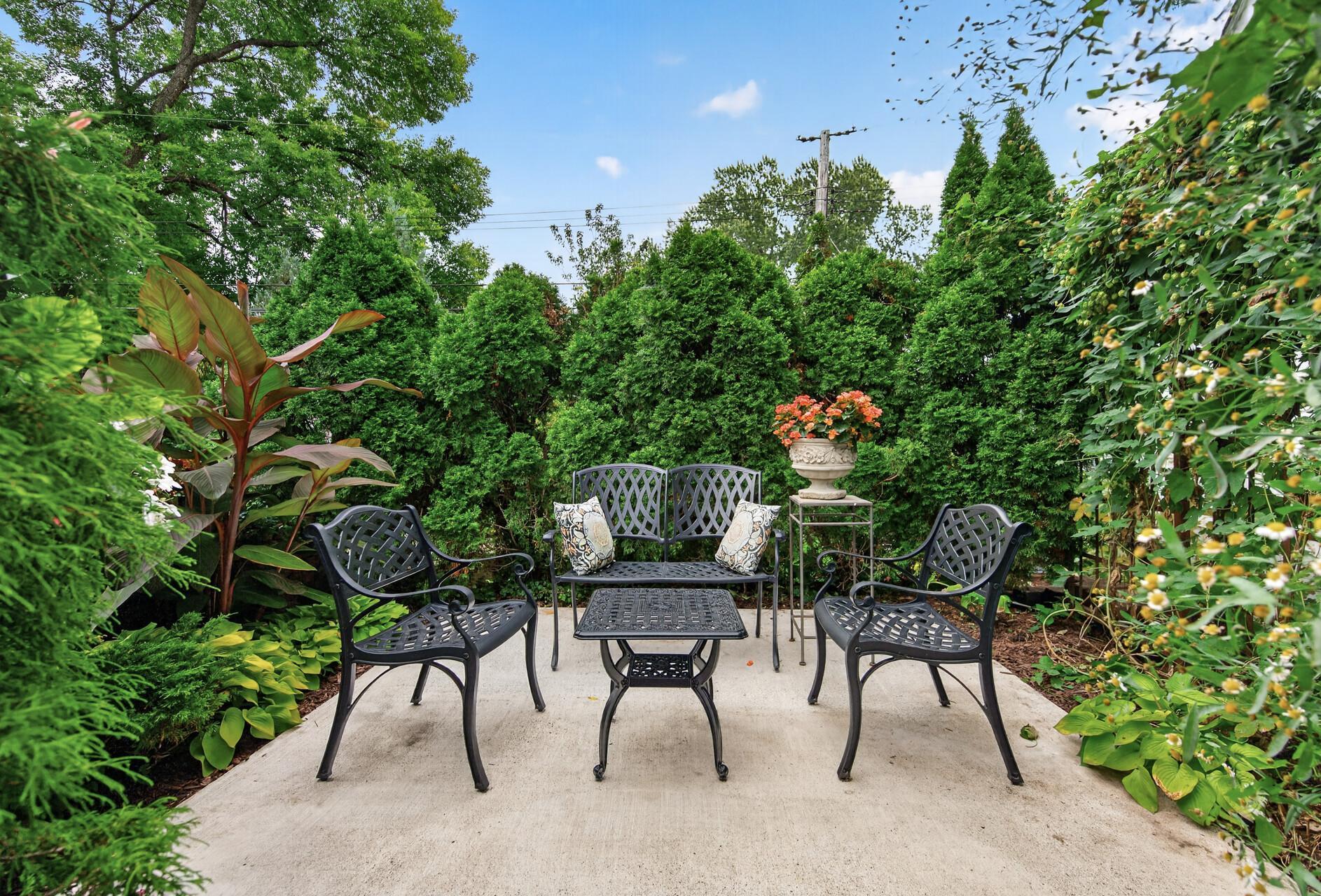 Garden seating area is spa-tub ready, with the pad and adjacent electrical already in place.