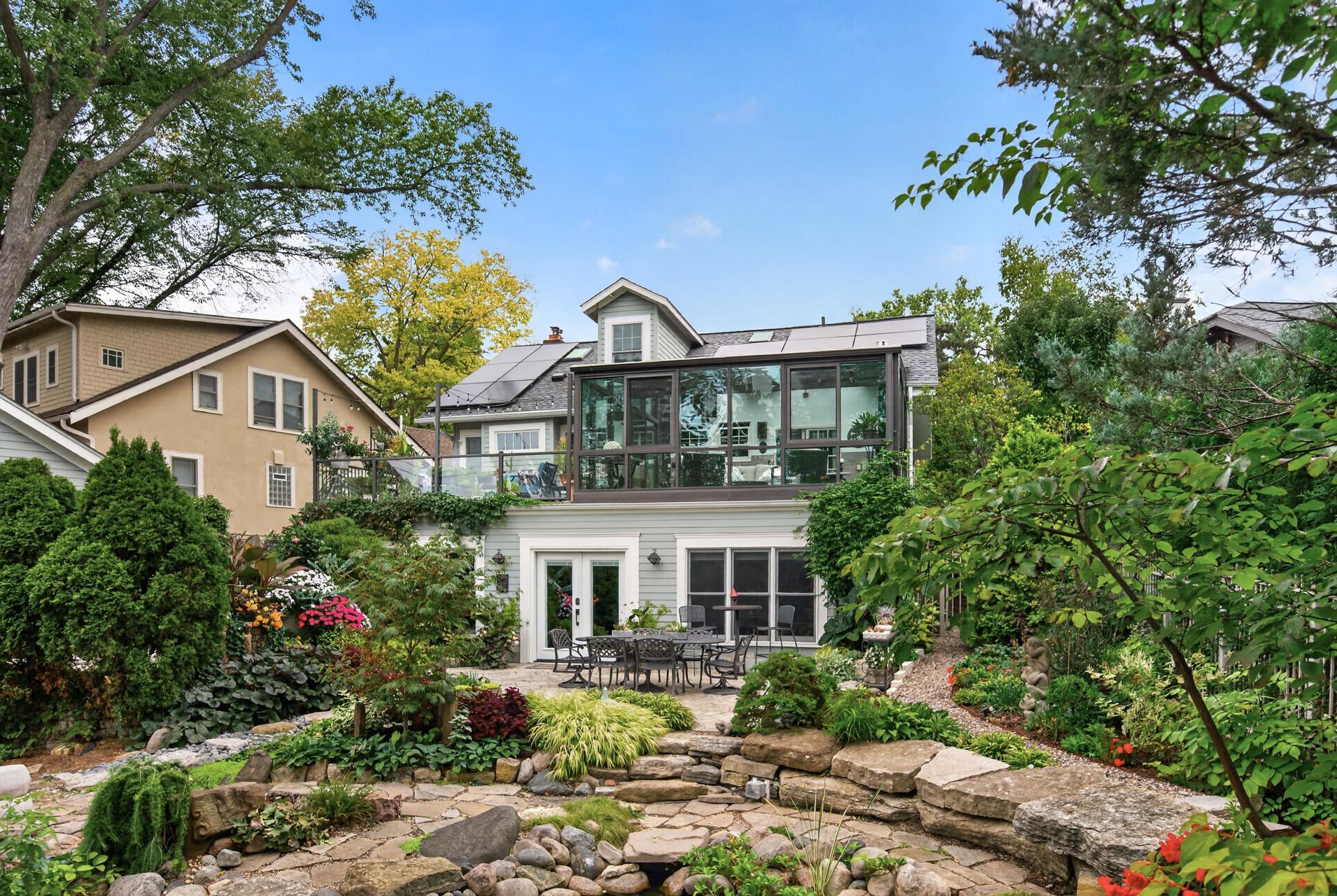 A wonderful view of the home’s multiple living spaces, including the patio, expansive deck and four-season solarium overlooking the gardens.