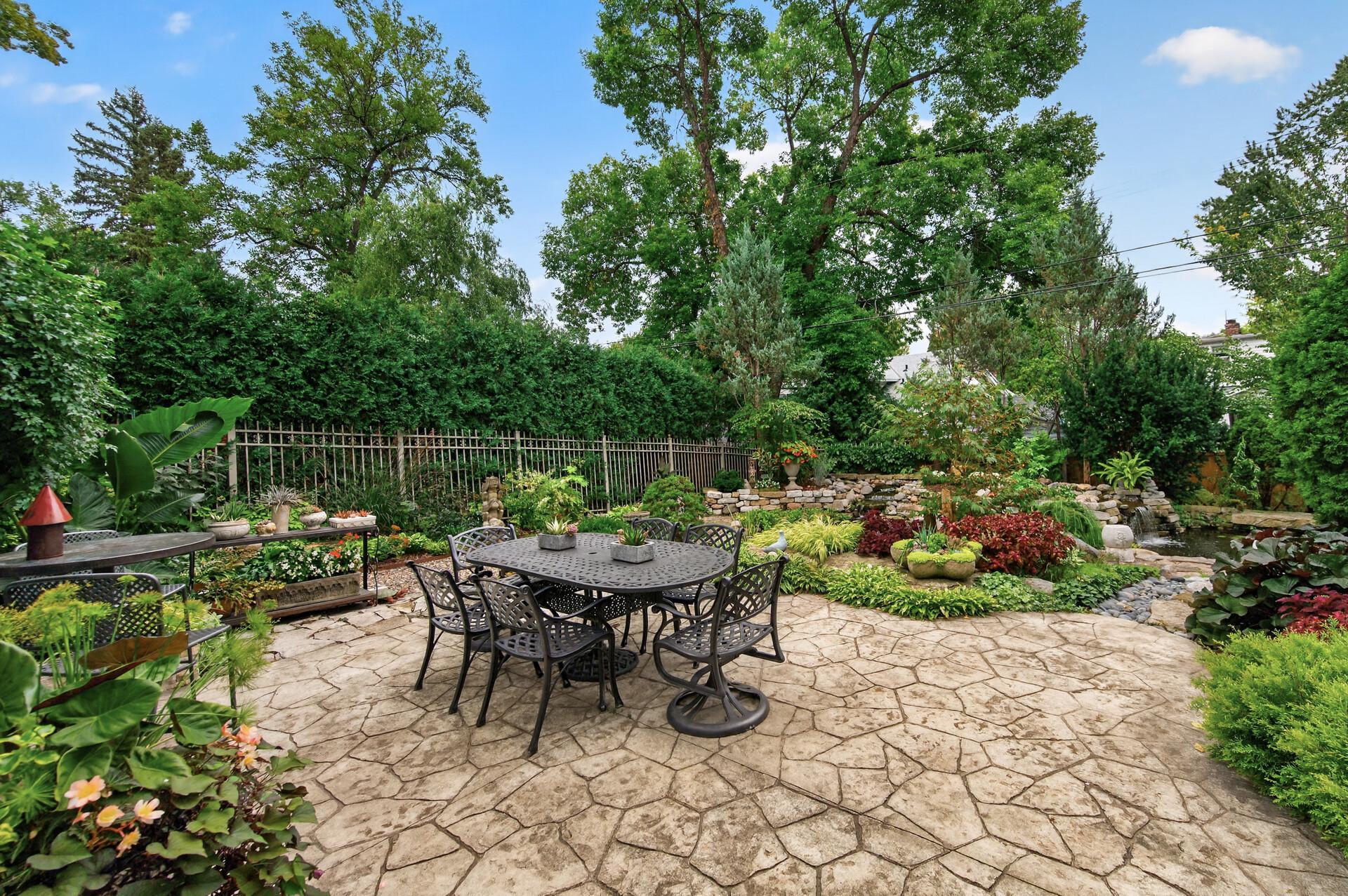 Large patio provides an inviting space within the gardens.