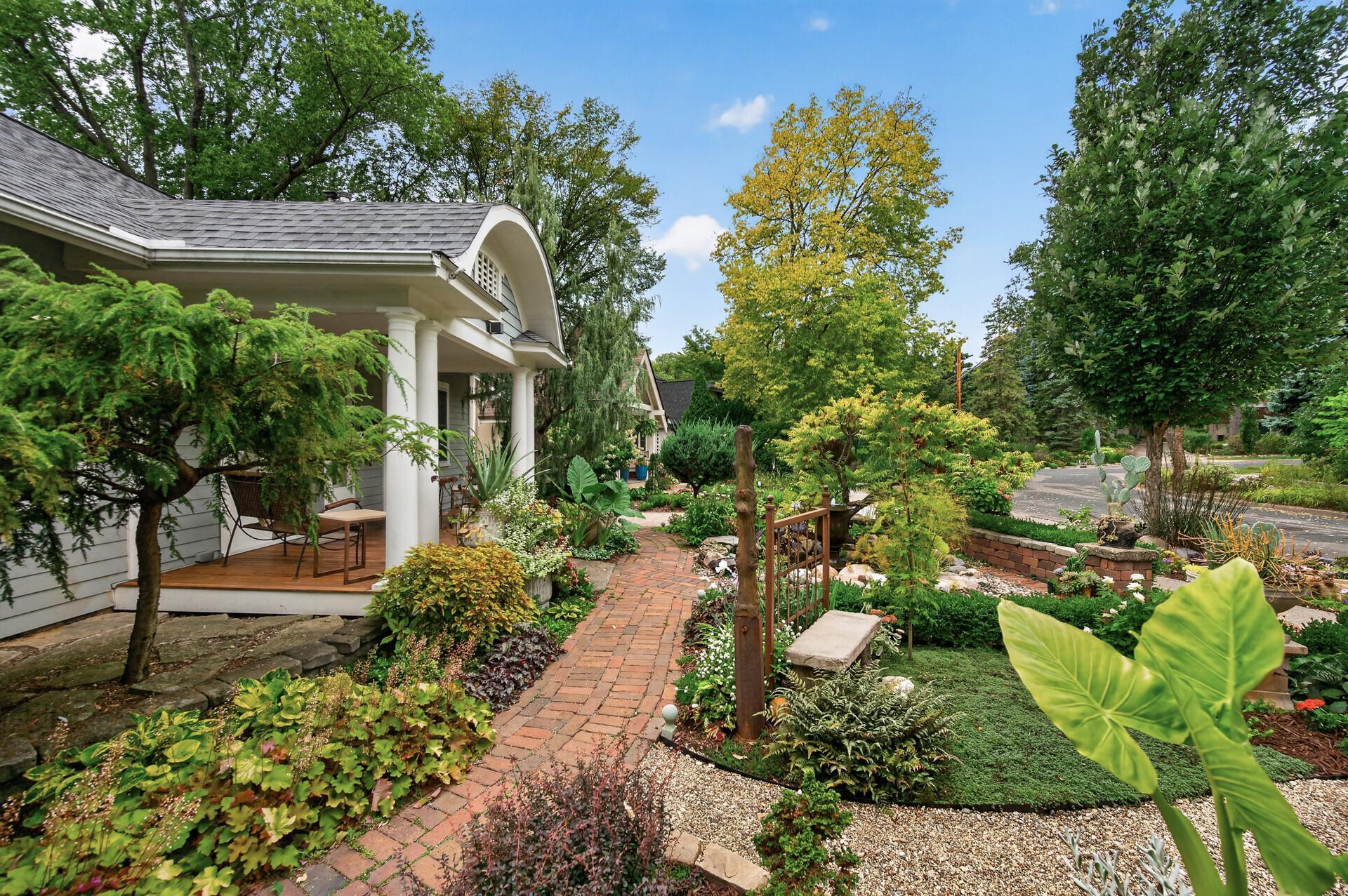 Meandering pathways invite you through the home's extensive gardens.