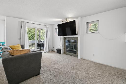 Living Room with Gas Fireplace and Sliding Door to the Deck