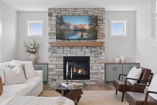 Gas burning fireplace with stone to the ceiling