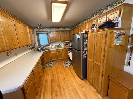 Part of kitchen, two windows. Stainless steal appliances.