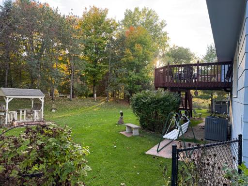 View off deck, back yard, many beautiful trees.