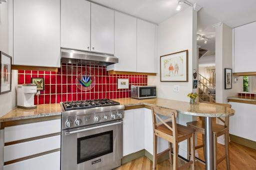 Thermador gas range, task lighting, and great countertop space for meal prep and informal dining