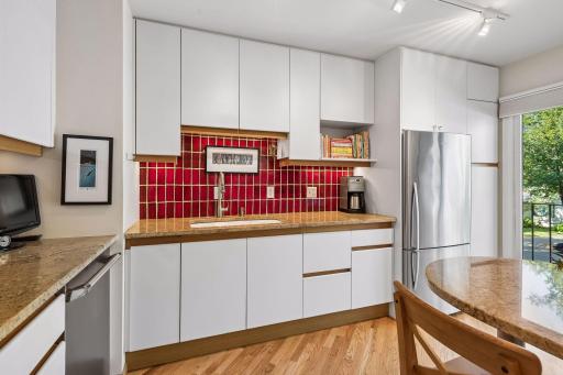 This kitchen features granite countertops, Thermador: dishwasher and gas stove, Fisher Paykel refrigerator, abundant cabinetry and pantry, plus peninsula seating.