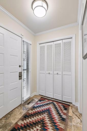 Foyer has a large closet for storage and easy access to the 1/2 bath.