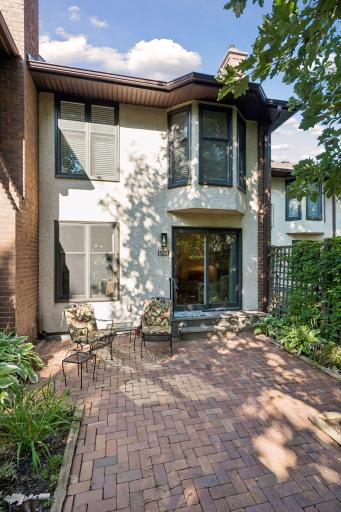 The paver patio adds charm to this backyard space. Great for outdoor entertaining and grilling. Amazing views of the courtyard/commons area. Lush greenery surrounds you!