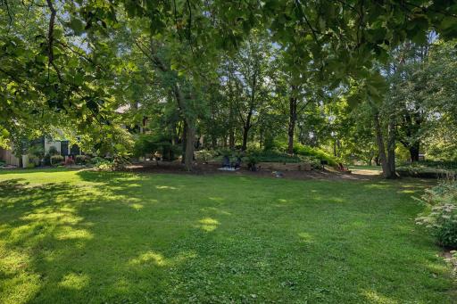 Lush greenery and trees provide a beautiful backdrop regardless of the season. An in-ground sprinkler system keeps the area inviting and ready for use!
