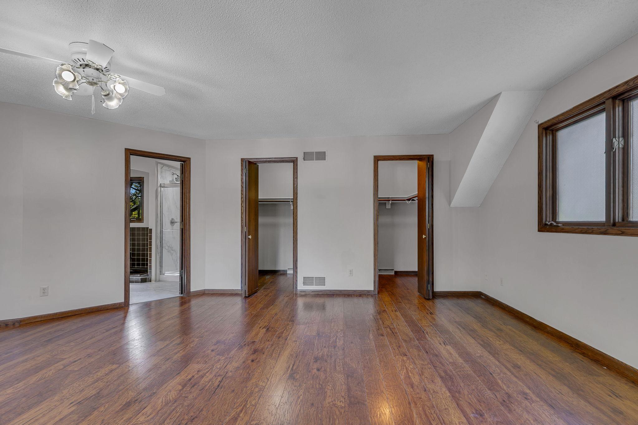 A primary owner's suite featuring double walk in closets and full private bath